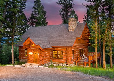 log cabin construction Big Sky, Montana front door and deck with sunset in background