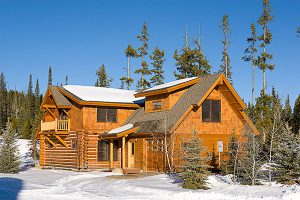 log cabin contsruction in big sky Montana exterior with woods surrounding