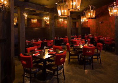 andiamo restaurant in big sky interior dining area plush red chairs