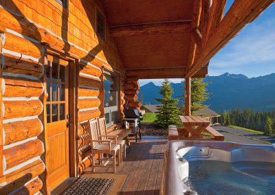 cowboy heaven exterior with large hot tubs and mountains in the background