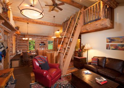 cowboy heaven interior living room with stairs leading to loft area