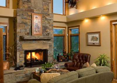cummings interior living room with stone fireplace and rustic finishes