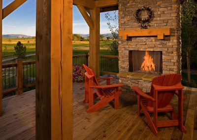 black bull clubhouse porch with wooden chairs and fireplace overlooking golf course