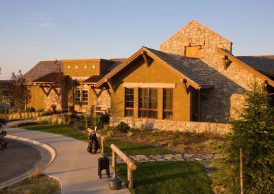 Black Bull STC Clubhouse exterior driveway area with rock path and golf bag