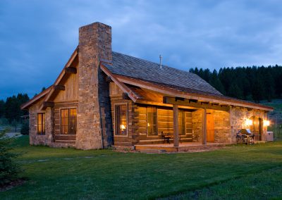 exterior of a house modeled in the style of an old forest service cabin wide angle shot at dusk