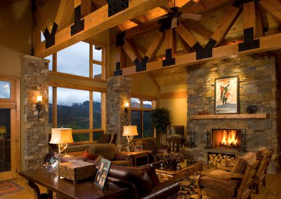 merritt interior living room with rustic beams and stone fireplace